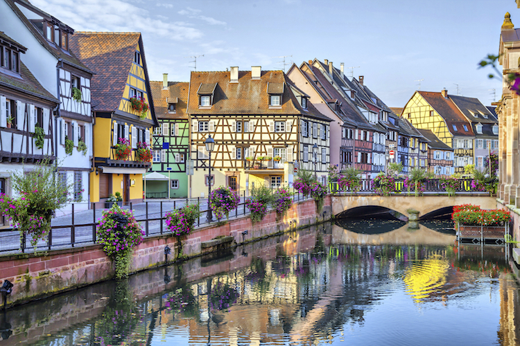 Brightly coloured houses along the canals at Colmar. Credit: iStock.com/bbsferrari.